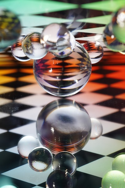 White and black stripes, transparent glass ball on the table
